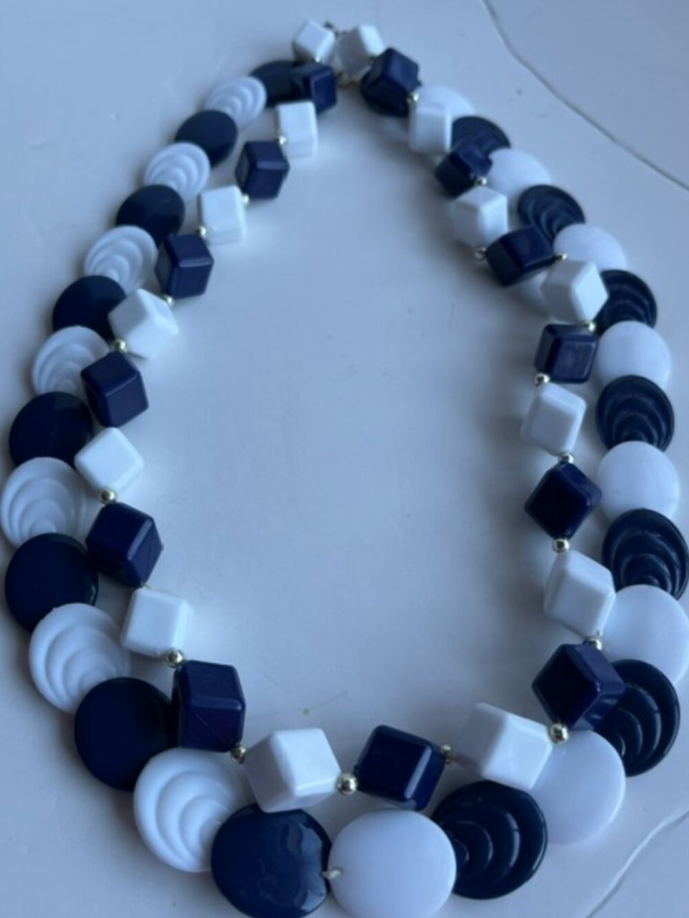 Pair of geometric shaped necklaces.